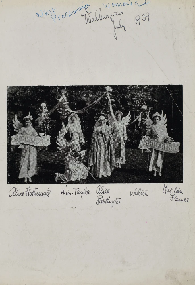 Women dressed as angels with wings and banners take part in the Whit procession, named as Alice Hothersall, Win. Taylor, Alice Partington, Walton and Matilda France.