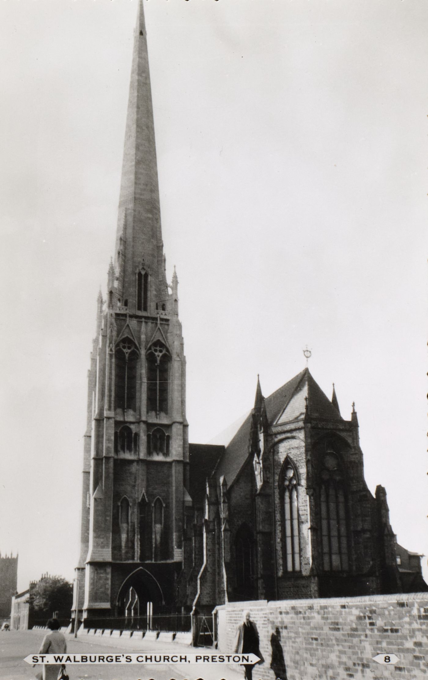 Printed postcard of St Walburge's from the street, the spire rising above the apse and east end, captioned "St Walburge's Church, Preston."
