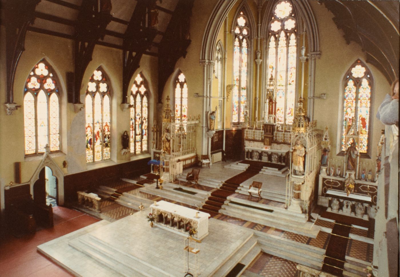 Colour photograph of St Walburge's sanctuary seen from a raised vantage, a freestanding forward altar in the foreground and the original high altar and side altars behind.