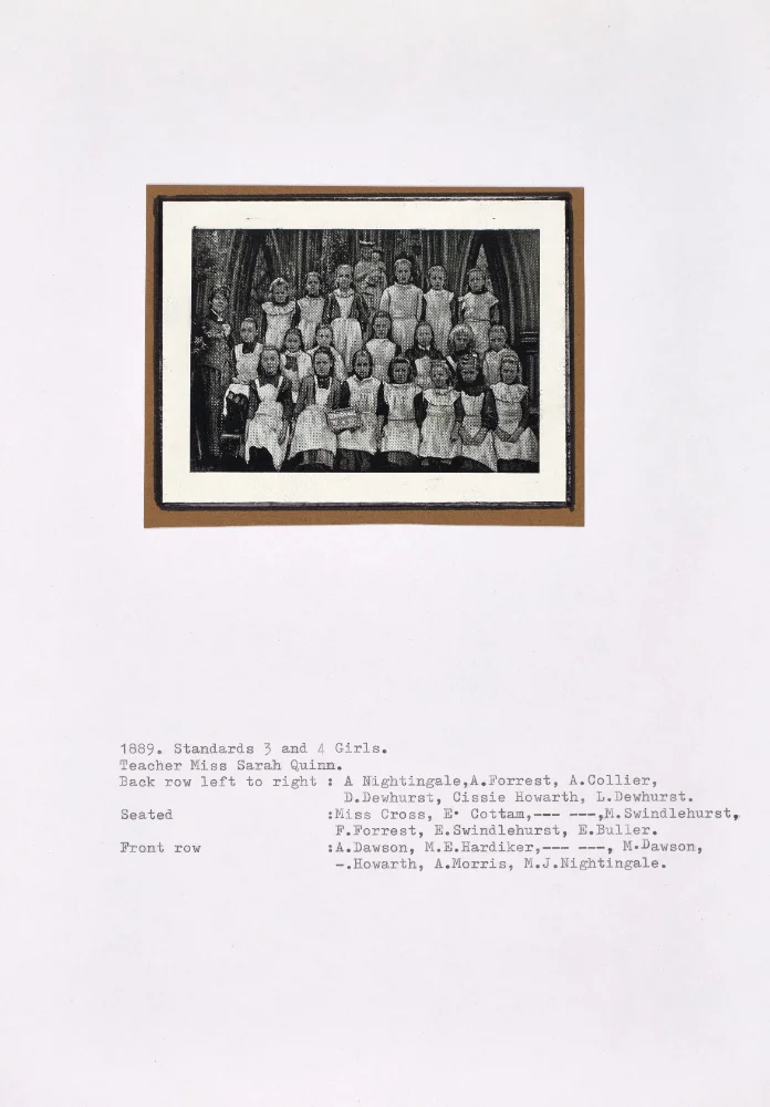 Class photograph of Standards 3 and 4 girls with teacher Miss Sarah Quinn, mounted with a typed caption listing pupils by name.