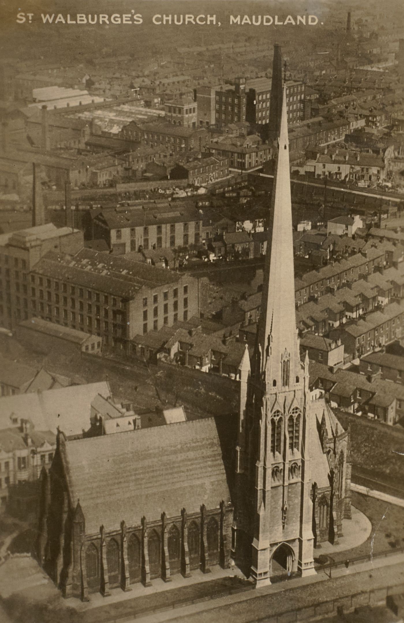 Printed postcard showing an aerial view of St Walburge's church and spire rising above the terraced streets and mill buildings of Maudland, captioned "St Walburge's Church, Maudland.